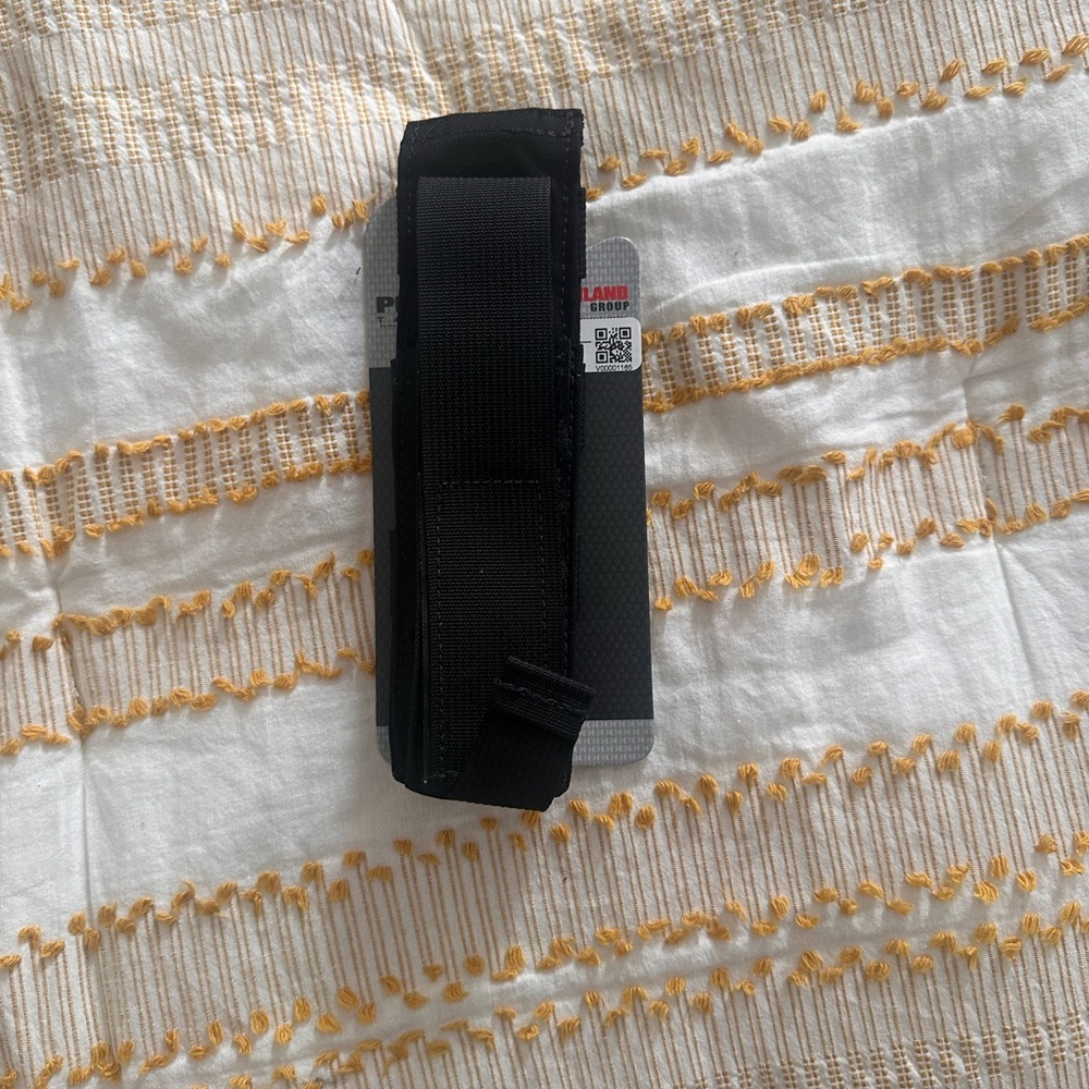 Safariland black tourniquet holder. Fabric material.